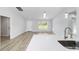 Bright living room featuring a quartz countertop, lots of lighting, and an open layout leading to dining area at 13384 Sw 105 Pl, Dunnellon, FL 34432
