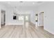 Spacious living room with contemporary light fixtures, pristine white walls, and an inviting open layout at 13384 Sw 105 Pl, Dunnellon, FL 34432
