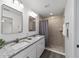 Modern bathroom featuring double vanities with granite countertops and a tiled shower at 13495 Sw 114Th Ln, Dunnellon, FL 34432
