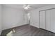 This bedroom includes a ceiling fan, light gray floors, and a closet at 13495 Sw 114Th Ln, Dunnellon, FL 34432