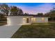 Well-lit single-story home with an attached two-car garage and a neatly prepped lawn at 13495 Sw 114Th Ln, Dunnellon, FL 34432