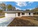 Charming single-story home with a two-car garage and a well-manicured front yard at 13495 Sw 114Th Ln, Dunnellon, FL 34432