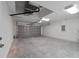 This garage features a large roll-up door and an interior door at 13495 Sw 114Th Ln, Dunnellon, FL 34432