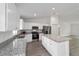 Bright kitchen with white cabinets, granite counters, stainless appliances, and a center island for extra prep space at 13495 Sw 114Th Ln, Dunnellon, FL 34432