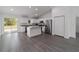 Modern kitchen features white cabinetry, granite countertops, stainless steel appliances, and a breakfast bar at 13495 Sw 114Th Ln, Dunnellon, FL 34432