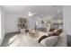 Bright living room featuring neutral tones, modern furniture, and an open floor plan to the kitchen and dining area at 13495 Sw 114Th Ln, Dunnellon, FL 34432