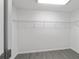 Empty walk-in closet featuring wire shelving and sleek gray flooring at 13495 Sw 114Th Ln, Dunnellon, FL 34432