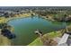 Scenic aerial view of community lake with gazebo and lush landscaping at 13751 Se 88Th Ct, Summerfield, FL 34491