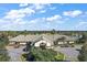 Aerial view of the community clubhouse with manicured grounds and golf cart parking at 13751 Se 88Th Ct, Summerfield, FL 34491