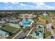 Aerial view of community amenities including a pool, bocce ball, shuffleboard, and putting green at 13751 Se 88Th Ct, Summerfield, FL 34491