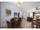 Inviting dining area with a ceiling light, a dining table, and an open view to the living room at 13751 Se 88Th Ct, Summerfield, FL 34491