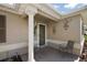 Inviting front porch with decorative wall art and seating, perfect for relaxing at 13751 Se 88Th Ct, Summerfield, FL 34491