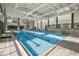 Bright indoor lap pool with large windows and ample natural light at 13751 Se 88Th Ct, Summerfield, FL 34491