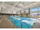Bright indoor lap pool with large windows and ample natural light at 13751 Se 88Th Ct, Summerfield, FL 34491