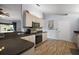 Modern kitchen boasting stainless steel appliances, a stylish countertop, and wood-look flooring at 13751 Se 88Th Ct, Summerfield, FL 34491