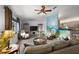 Bright and airy living room featuring laminate flooring, a ceiling fan, and an open concept layout at 13751 Se 88Th Ct, Summerfield, FL 34491