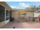 Cozy patio area featuring a patio swing, dining table set, privacy screening, and ample outdoor seating at 13751 Se 88Th Ct, Summerfield, FL 34491