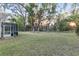 Expansive backyard with mature trees and a screened-in patio, offering privacy and outdoor enjoyment at 13920 Ne 38Th Ave, Anthony, FL 32617