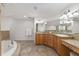 Bright bathroom featuring a tub and vanity with granite countertop and decorative lighting at 13920 Ne 38Th Ave, Anthony, FL 32617