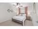 Cozy bedroom with neutral decor, ceiling fan, and plenty of natural light at 13920 Ne 38Th Ave, Anthony, FL 32617