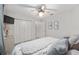 Cozy bedroom featuring a ceiling fan, double closet doors, and neutral decor at 13920 Ne 38Th Ave, Anthony, FL 32617