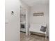 Inviting entryway with a cozy bench and convenient access to the laundry room, offering practicality and comfort at 13920 Ne 38Th Ave, Anthony, FL 32617