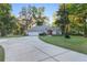 Well-maintained home with a long driveway, lush landscaping, and a charming fence line at 13920 Ne 38Th Ave, Anthony, FL 32617