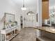 Bright foyer with a console table, decorative mirror and open view to the living spaces at 13920 Ne 38Th Ave, Anthony, FL 32617