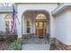 Inviting entryway featuring a wooden door, stone accents, and decorative brickwork at 13920 Ne 38Th Ave, Anthony, FL 32617