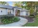Inviting front porch with stone accents, manicured landscaping, and a classic American flag at 13920 Ne 38Th Ave, Anthony, FL 32617