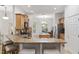 Kitchen featuring wooden cabinets, granite countertops, stainless-steel appliances and breakfast bar seating at 13920 Ne 38Th Ave, Anthony, FL 32617