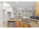 Bright kitchen with granite counters, stainless steel appliances, and open floor plan at 13920 Ne 38Th Ave, Anthony, FL 32617