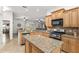 Open kitchen design showcasing stainless steel appliances, granite countertops, and a large island at 13920 Ne 38Th Ave, Anthony, FL 32617