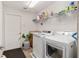 Functional laundry room with modern washer, dryer, ample storage, and sink for added convenience at 13920 Ne 38Th Ave, Anthony, FL 32617