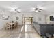 Open-concept living room and dining area with tiled floors and views of the outdoor space through sliding glass doors at 13920 Ne 38Th Ave, Anthony, FL 32617