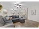 Spacious living room with a comfortable sectional couch, large sliding doors, and tiled floors at 13920 Ne 38Th Ave, Anthony, FL 32617