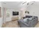 Bright living room featuring a large sectional, neutral walls, and tiled floors for easy maintenance at 13920 Ne 38Th Ave, Anthony, FL 32617