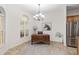 Bright home office adjacent to the kitchen, featuring a large window and desk at 13920 Ne 38Th Ave, Anthony, FL 32617