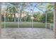 Screened-in patio with brick flooring and views of the expansive backyard and mature trees at 13920 Ne 38Th Ave, Anthony, FL 32617