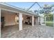 Large brick-paved patio with ceiling fans and an outdoor kitchen area, perfect for entertaining at 13920 Ne 38Th Ave, Anthony, FL 32617
