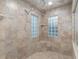 Elegant tiled shower featuring dual shower heads and decorative glass block windows for natural light at 13920 Ne 38Th Ave, Anthony, FL 32617