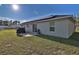 Back of home showcasing solar panels, patio, grill and expansive backyard at 14 Hemlock Loop Court, Ocala, FL 34472