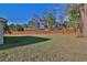 Fenced backyard with well-maintained lawn and mature trees at 14 Hemlock Loop Court, Ocala, FL 34472