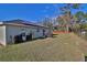 Extensive backyard showing the house with solar panels and fenced perimeter at 14 Hemlock Loop Court, Ocala, FL 34472