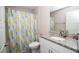 Bathroom featuring a stylish vanity with granite countertop, modern fixtures, and a shower with colorful curtain at 14 Hemlock Loop Court, Ocala, FL 34472
