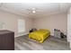 Spacious bedroom features tray ceiling, ceiling fan, and large window which creates an inviting atmosphere at 14 Hemlock Loop Court, Ocala, FL 34472