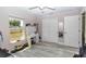 Spacious bedroom with large windows, light gray floors, a large mirror, and closet space, offering a comfortable environment at 14 Hemlock Loop Court, Ocala, FL 34472