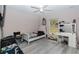 Bright bedroom with light gray floors, a white bed, vanity area, and a large window, creating a peaceful retreat at 14 Hemlock Loop Court, Ocala, FL 34472