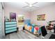 Cozy bedroom with a blue-themed decor, light-colored walls, and ample natural light from the window at 14 Hemlock Loop Court, Ocala, FL 34472