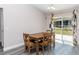 Cozy dining area featuring a wooden table with chairs, a sliding glass door, and stylish modern curtains at 14 Hemlock Loop Court, Ocala, FL 34472